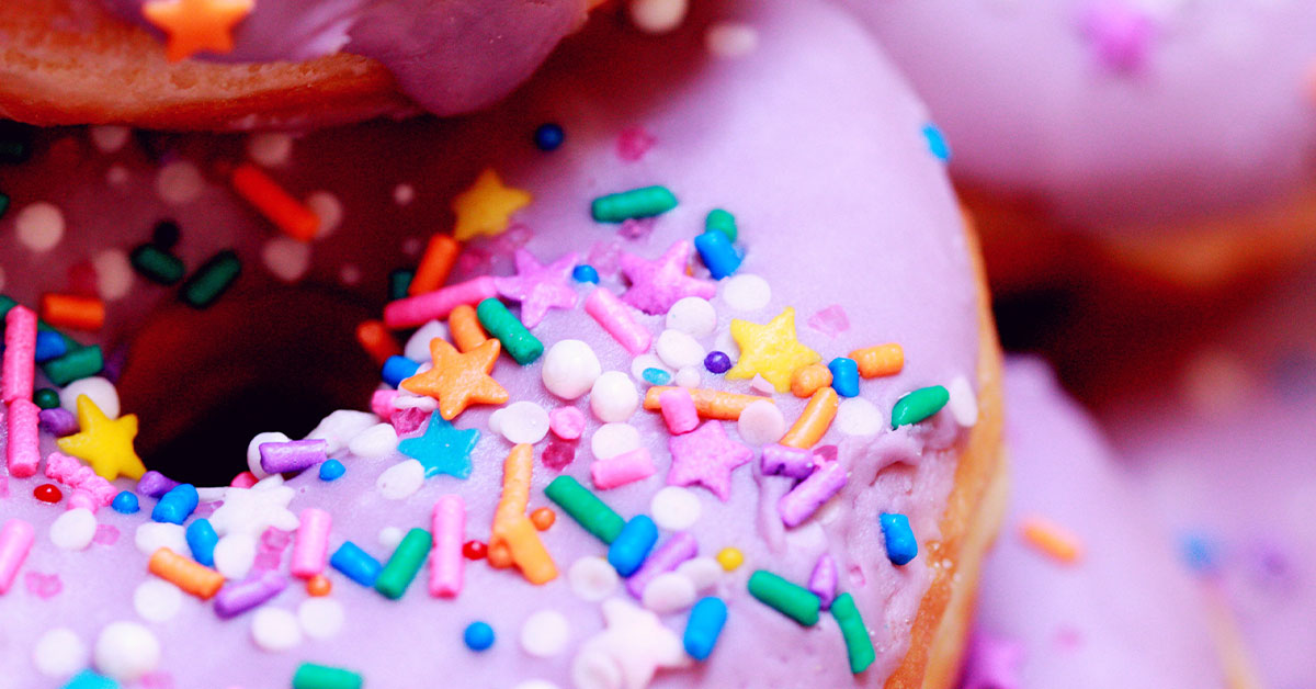 How sugar rots your teeth - an image of pink glazed donuts with sprinkles!